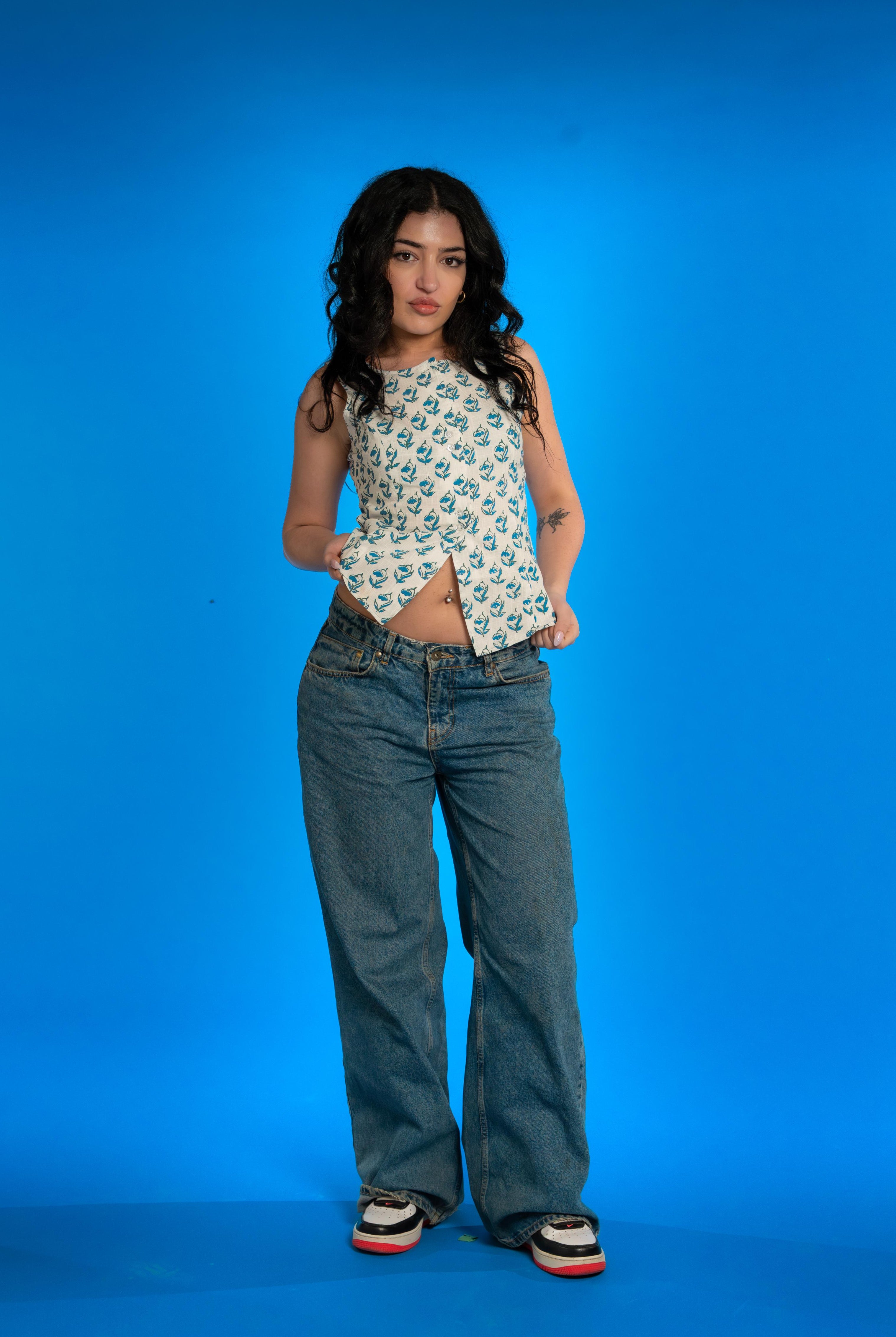 Handwoven cotton waistcoat with floral block-print motifs, tailored fit, and artisanal detailing—styled for modern, sustainable fashion.