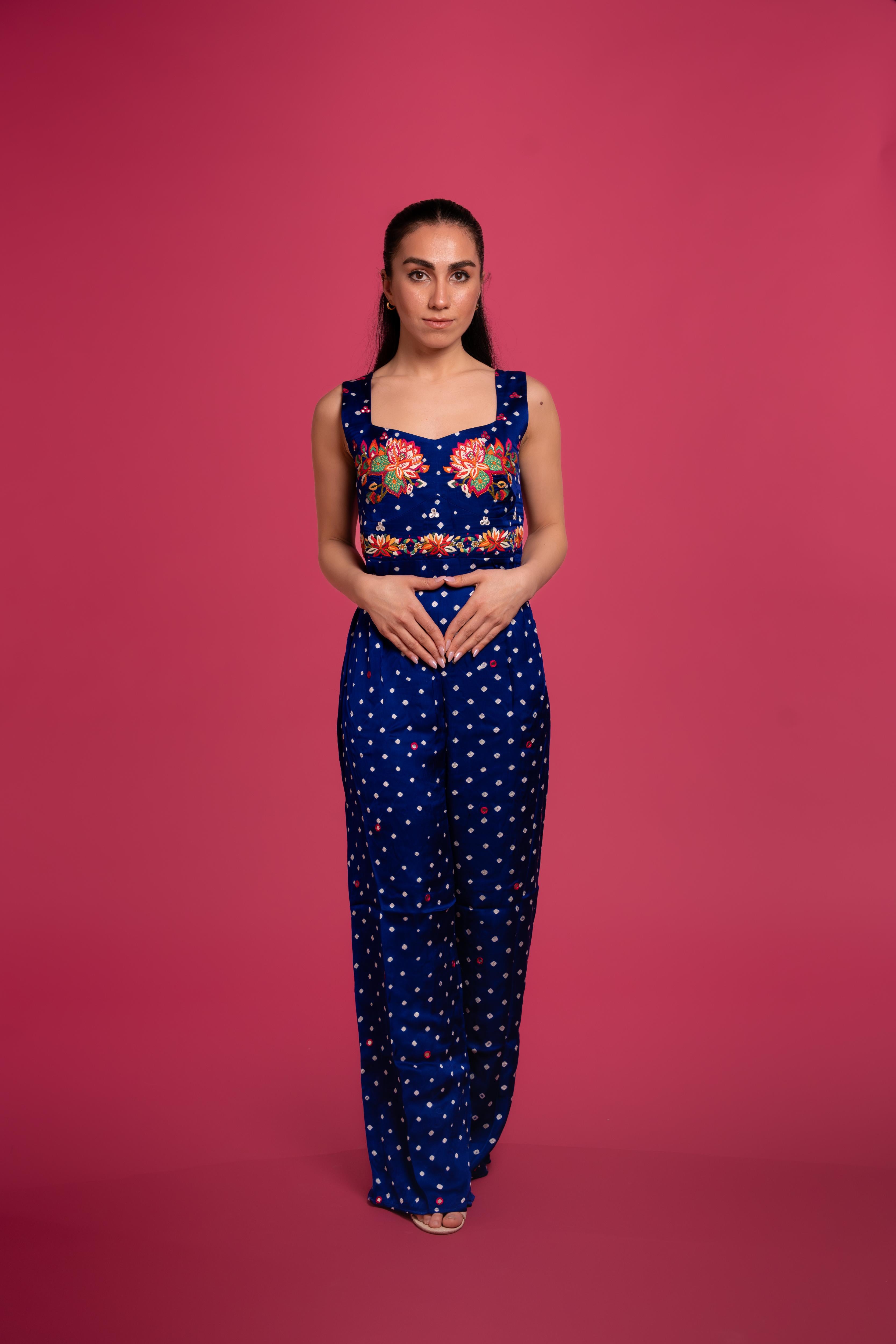 Bandhani tie-dye jumpsuit with lotus hand embroidery, and flowing wide-leg pants—blending tradition with modern elegance.