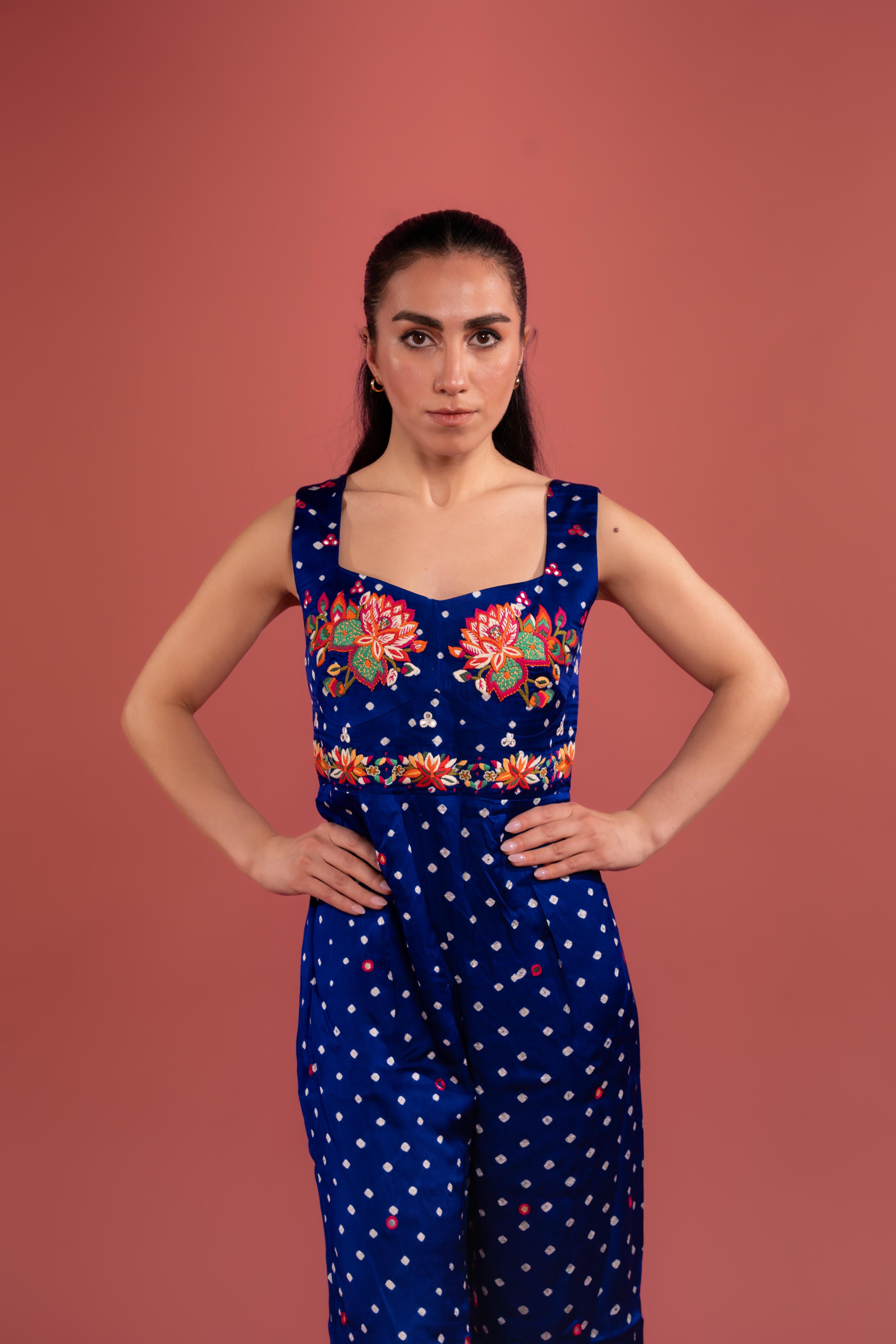 Bandhani tie-dye jumpsuit with lotus hand embroidery, and flowing wide-leg pants—blending tradition with modern elegance.