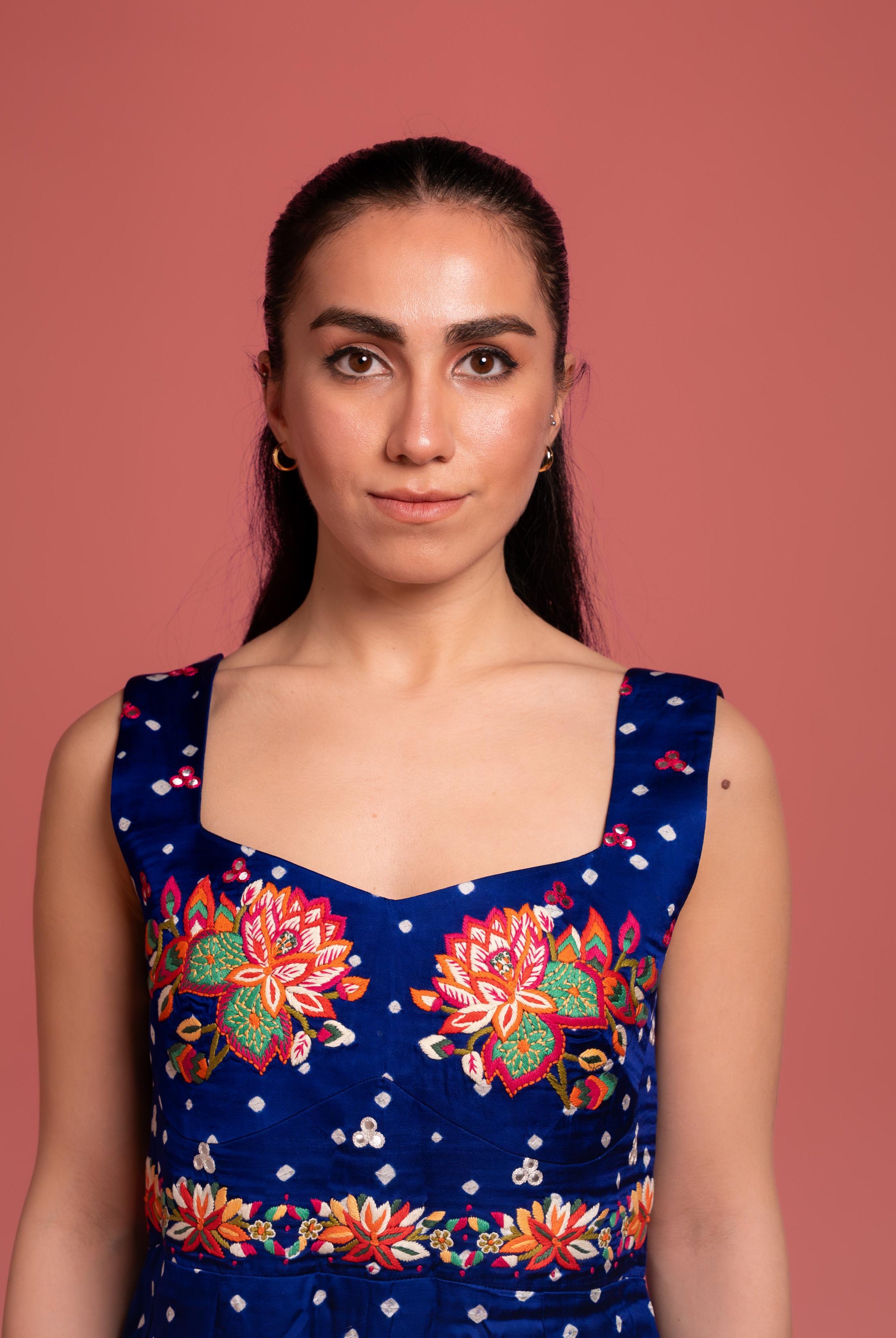 Bandhani tie-dye jumpsuit with lotus hand embroidery, and flowing wide-leg pants—blending tradition with modern elegance.