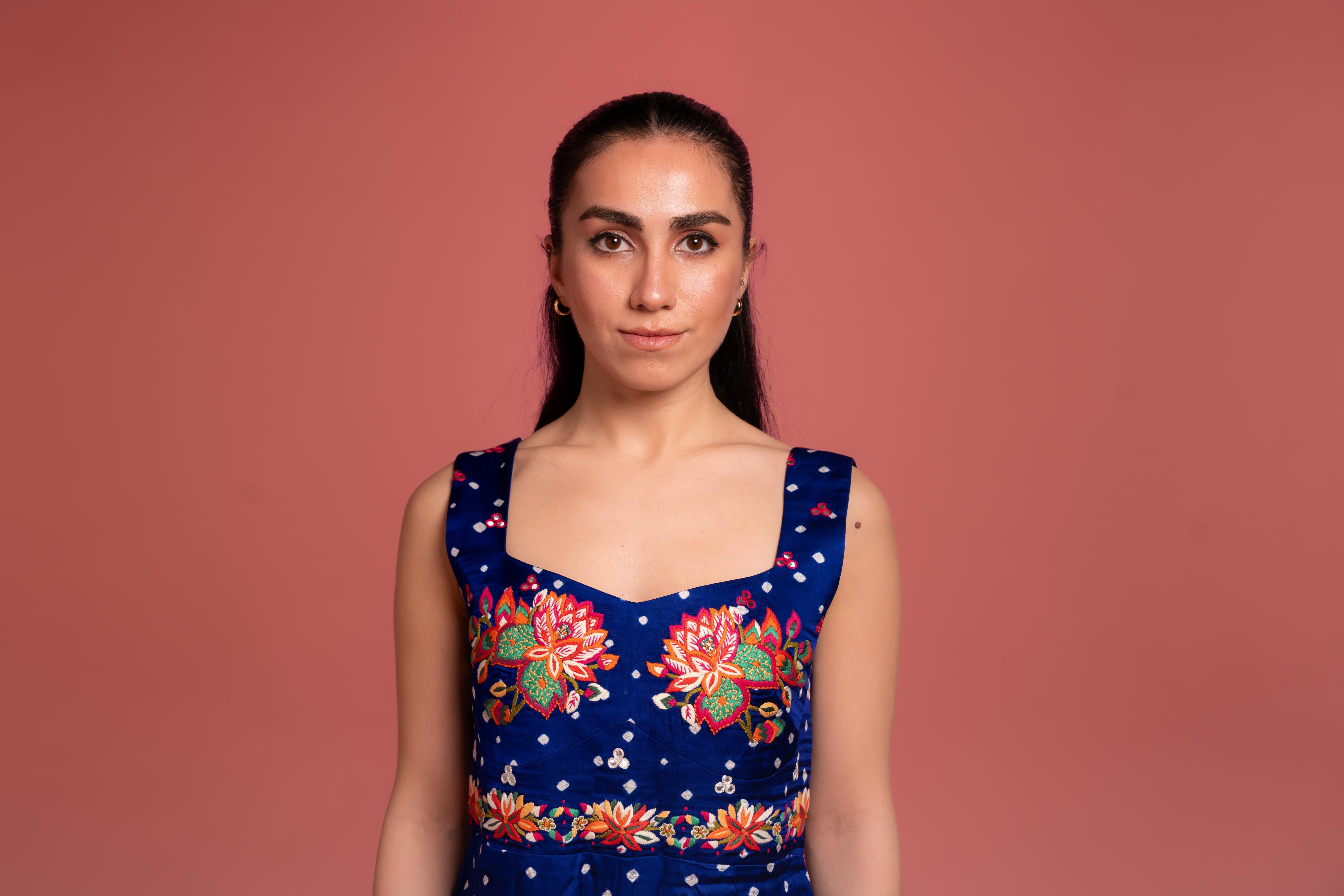 Bandhani tie-dye jumpsuit with lotus hand embroidery, and flowing wide-leg pants—blending tradition with modern elegance.