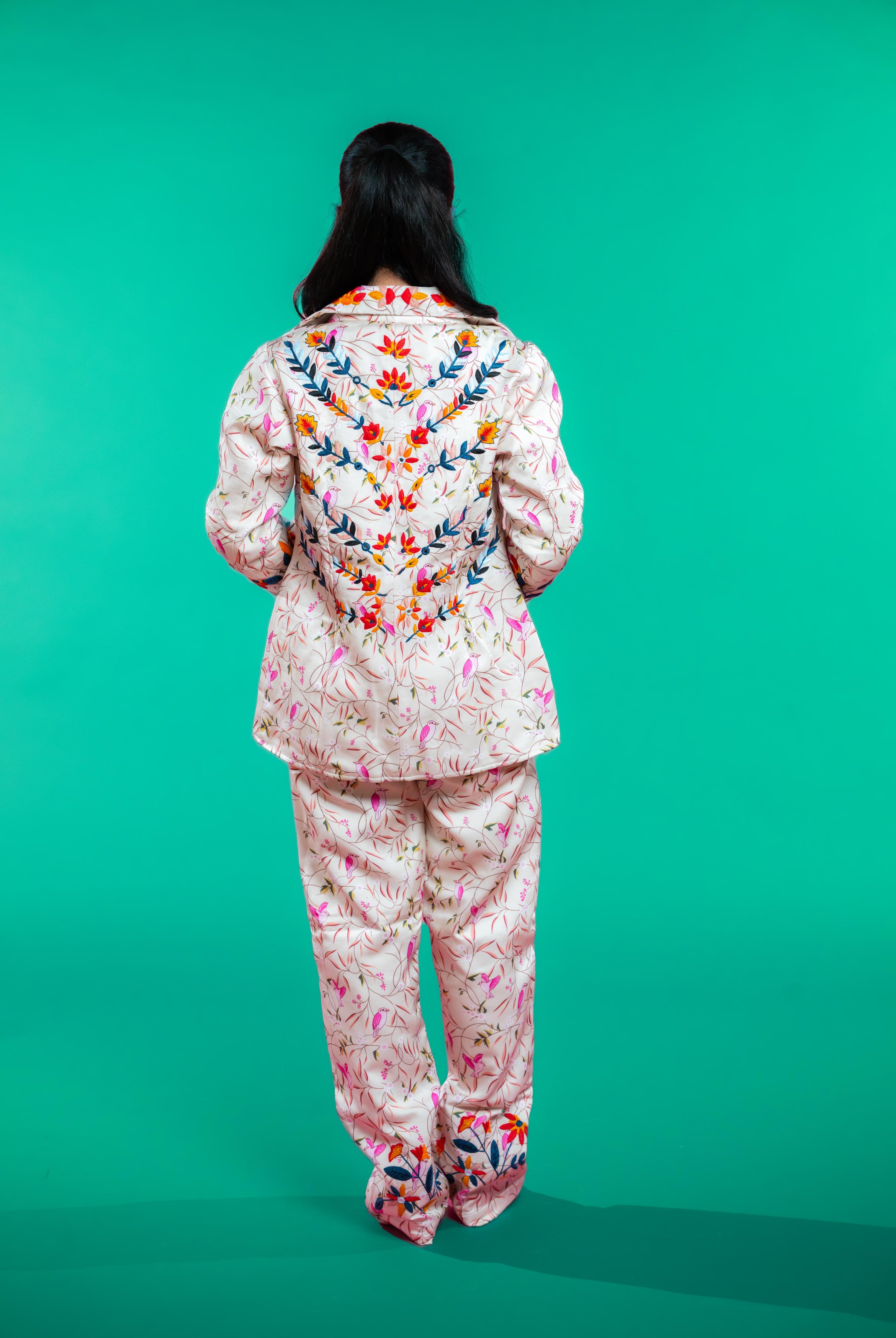 Artisan-crafted blazer and pants set featuring hand block-printed bird and foliage motifs with vibrant hand embroidery—designed for a cohesive, elegant, and sustainable look.