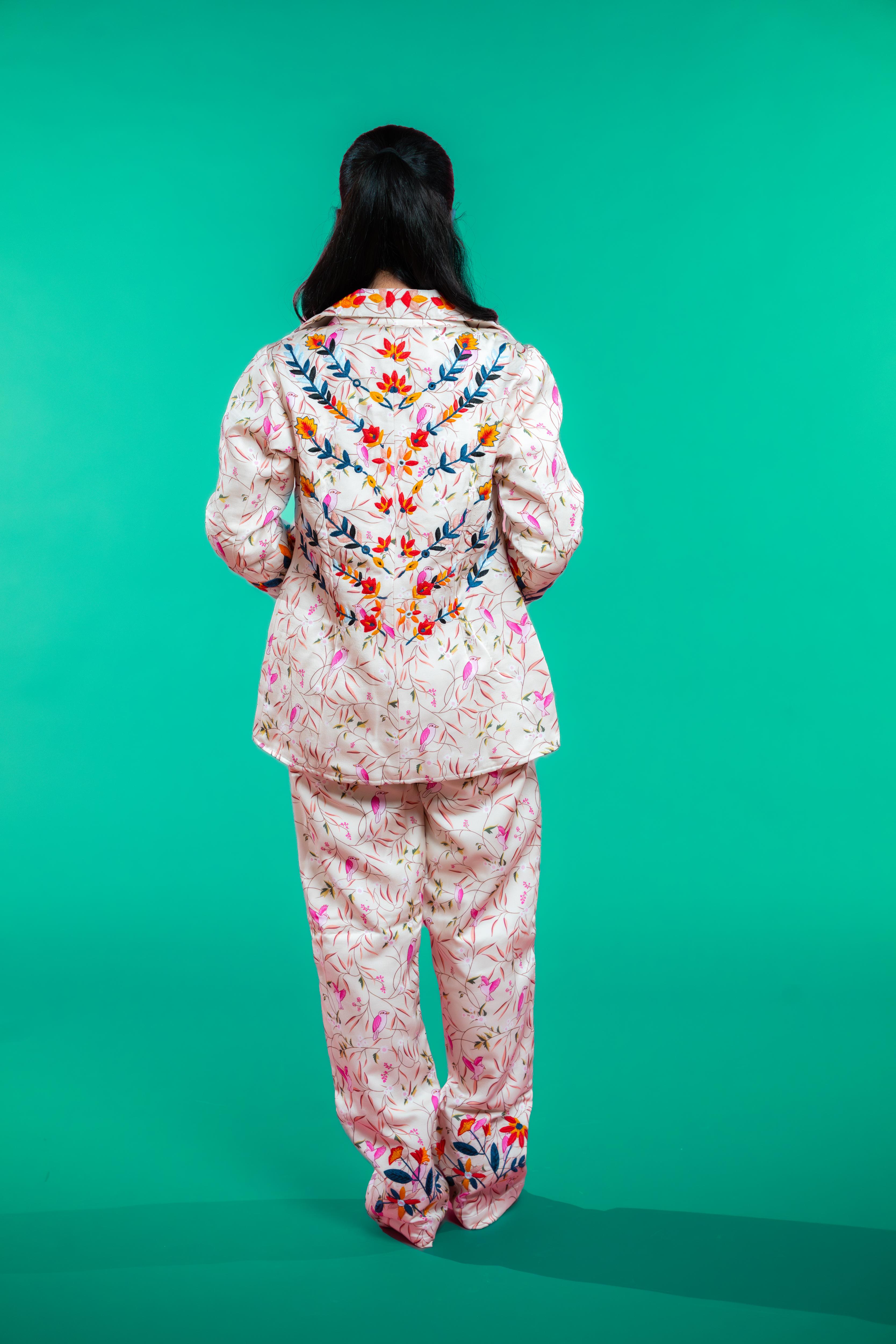 Artisan-crafted blazer and pants set featuring hand block-printed bird and foliage motifs with vibrant hand embroidery—designed for a cohesive, elegant, and sustainable look.