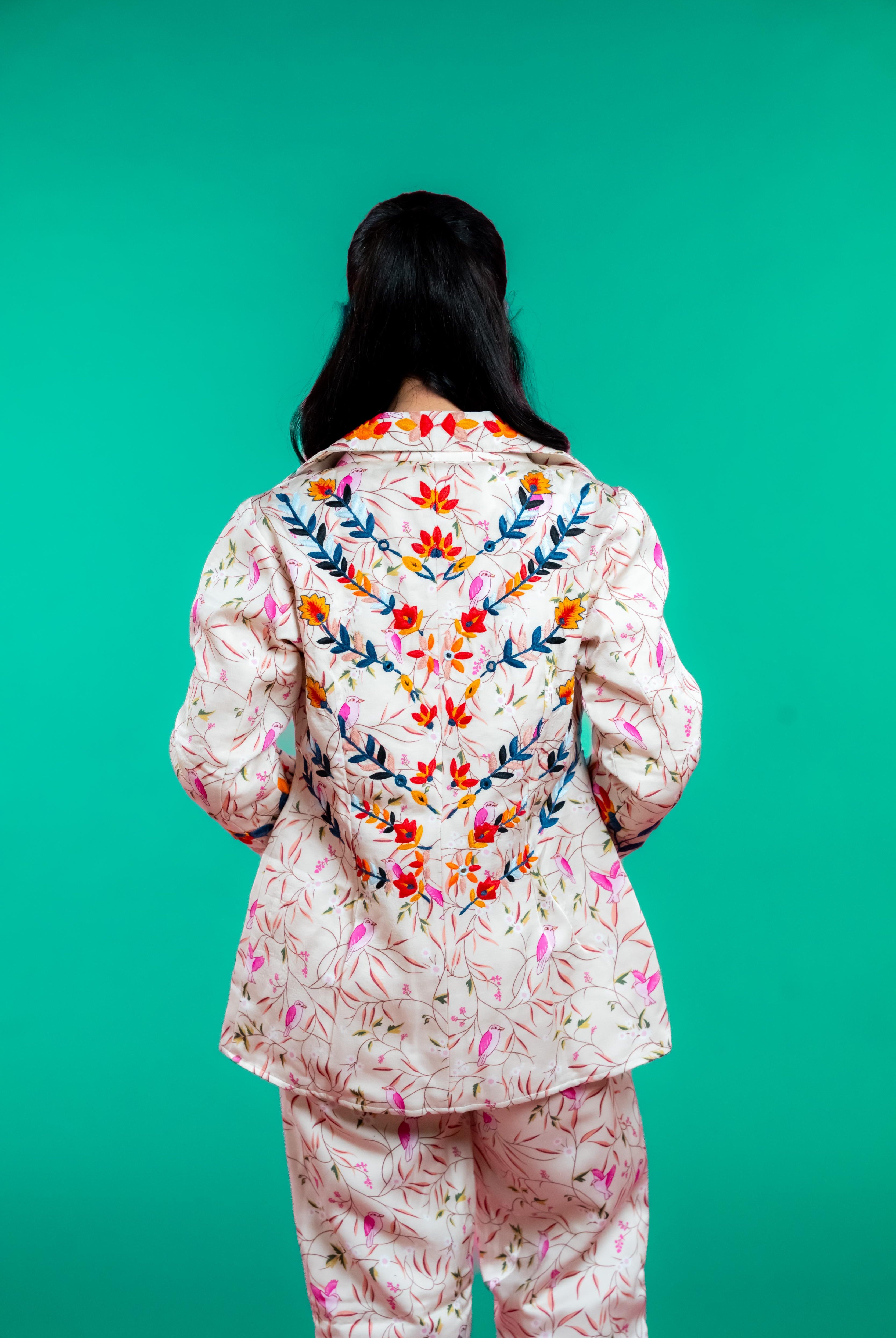 Artisan-crafted blazer and pants set featuring hand block-printed bird and foliage motifs with vibrant hand embroidery—designed for a cohesive, elegant, and sustainable look.