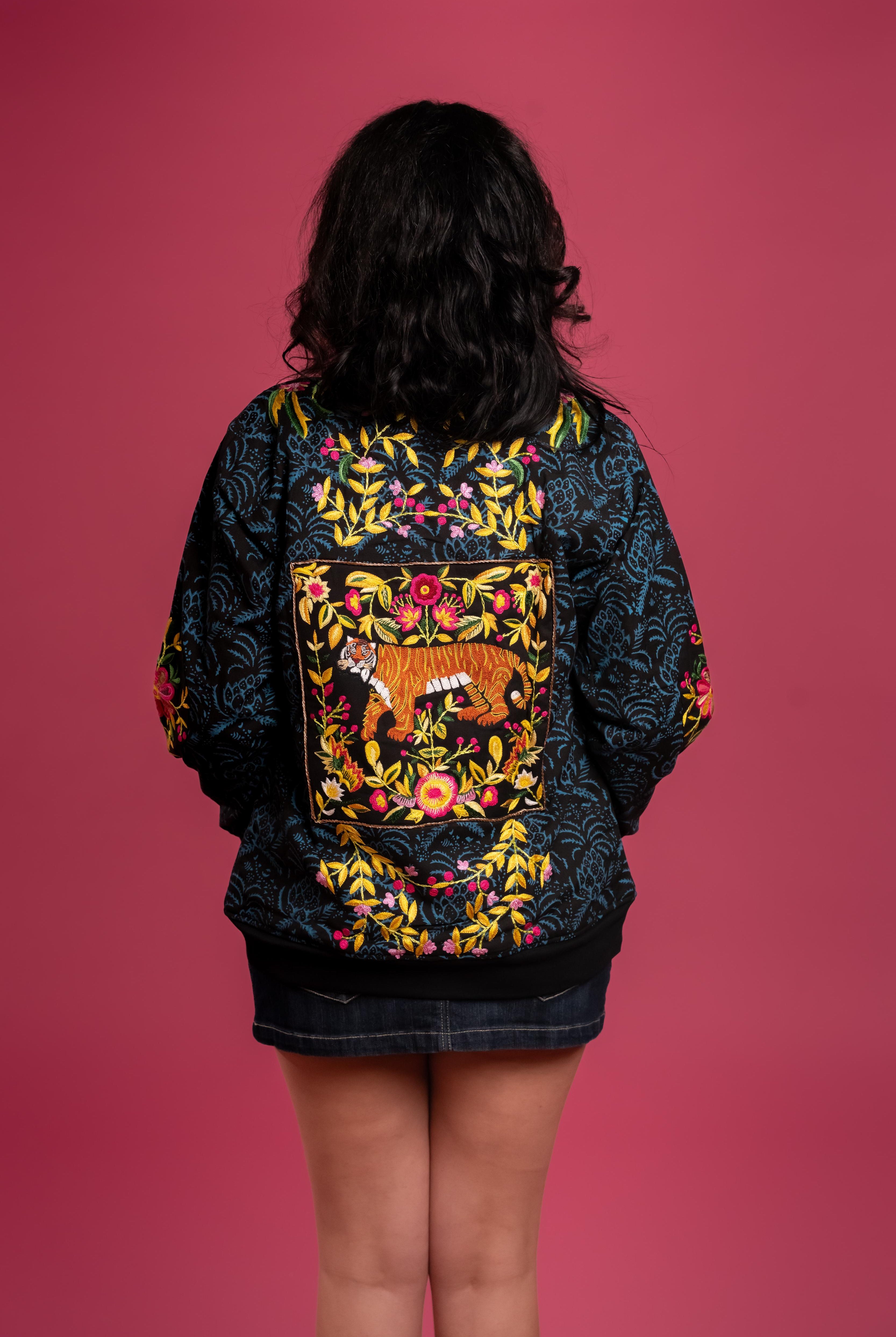 Hand block-printed bomber jacket with dyes, with floral embroidery and a bold hand-embroidered tiger on the back.