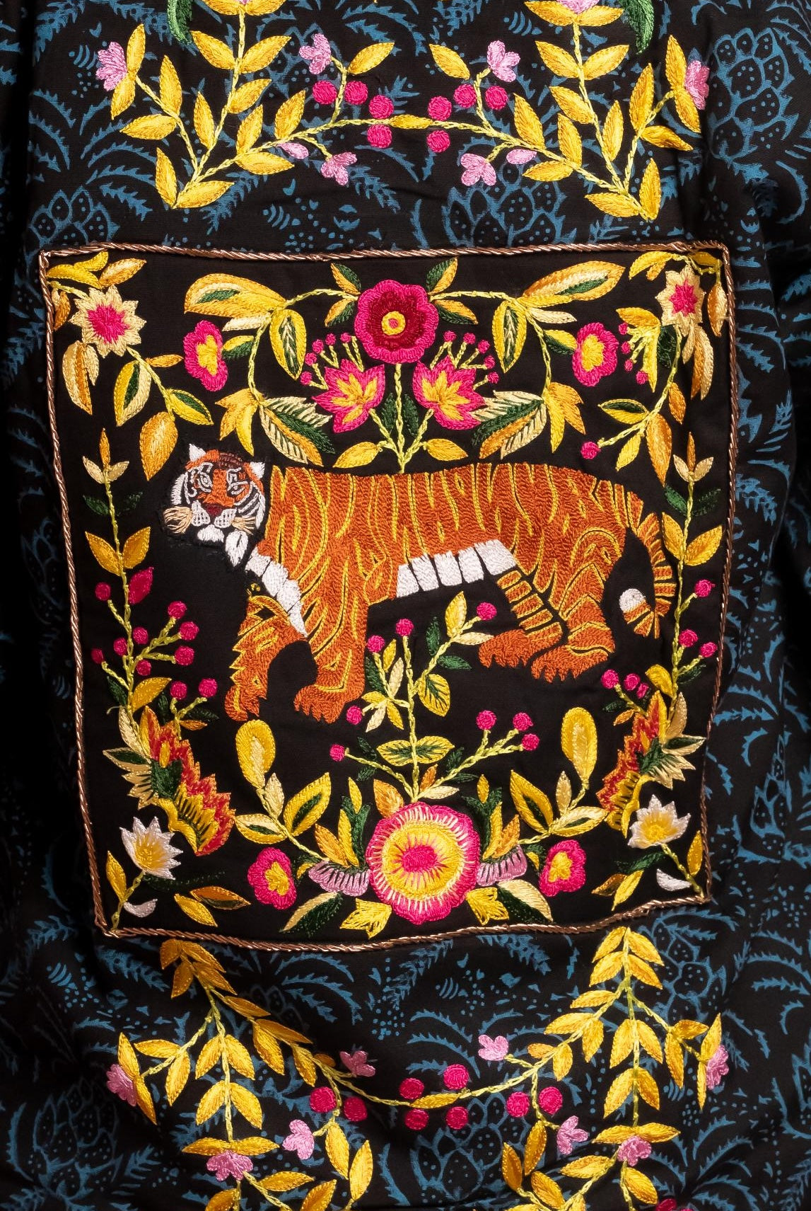 Hand block-printed bomber jacket with dyes, with floral embroidery and a bold hand-embroidered tiger on the back.