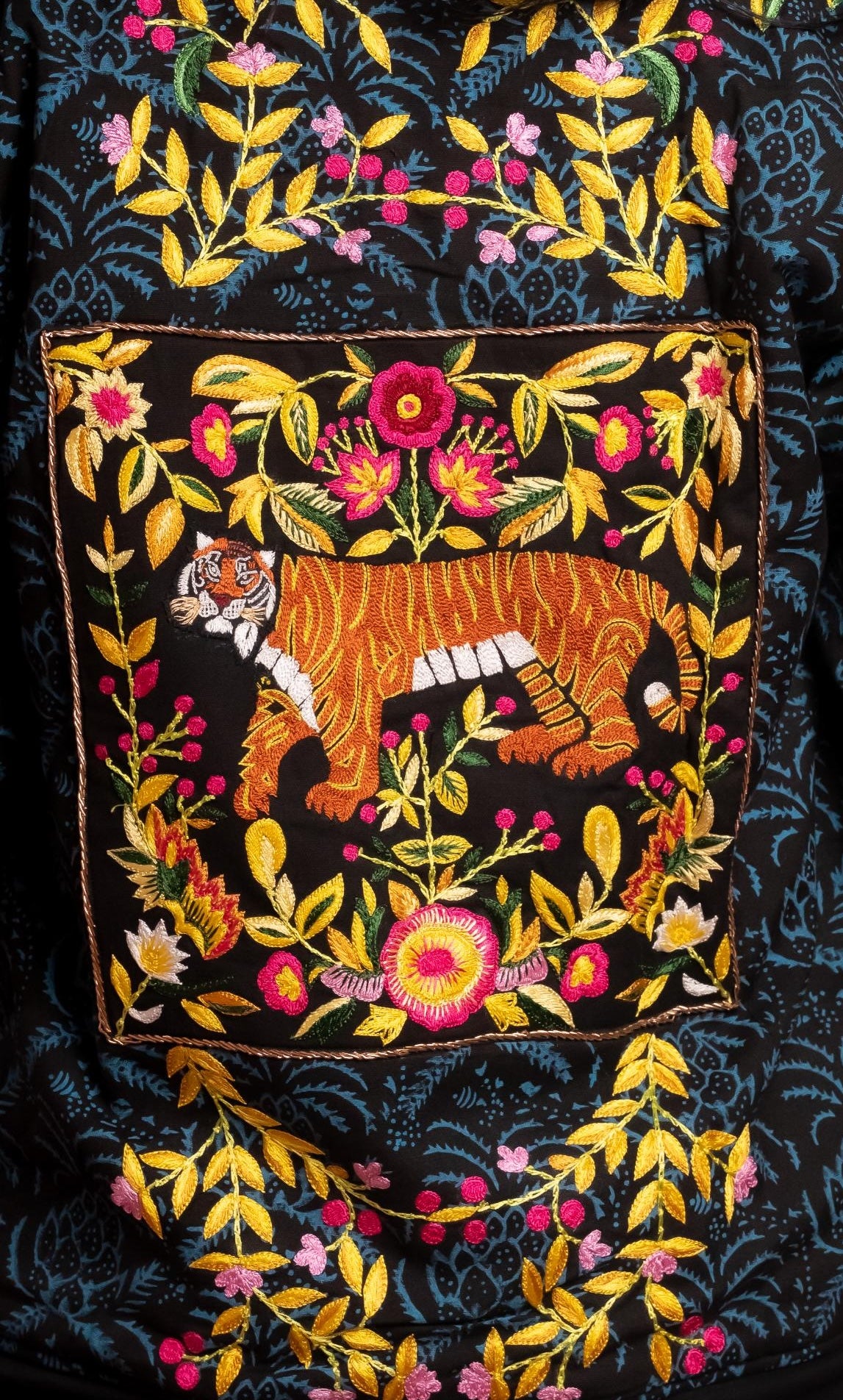 Hand block-printed bomber jacket with dyes, with floral embroidery and a bold hand-embroidered tiger on the back.